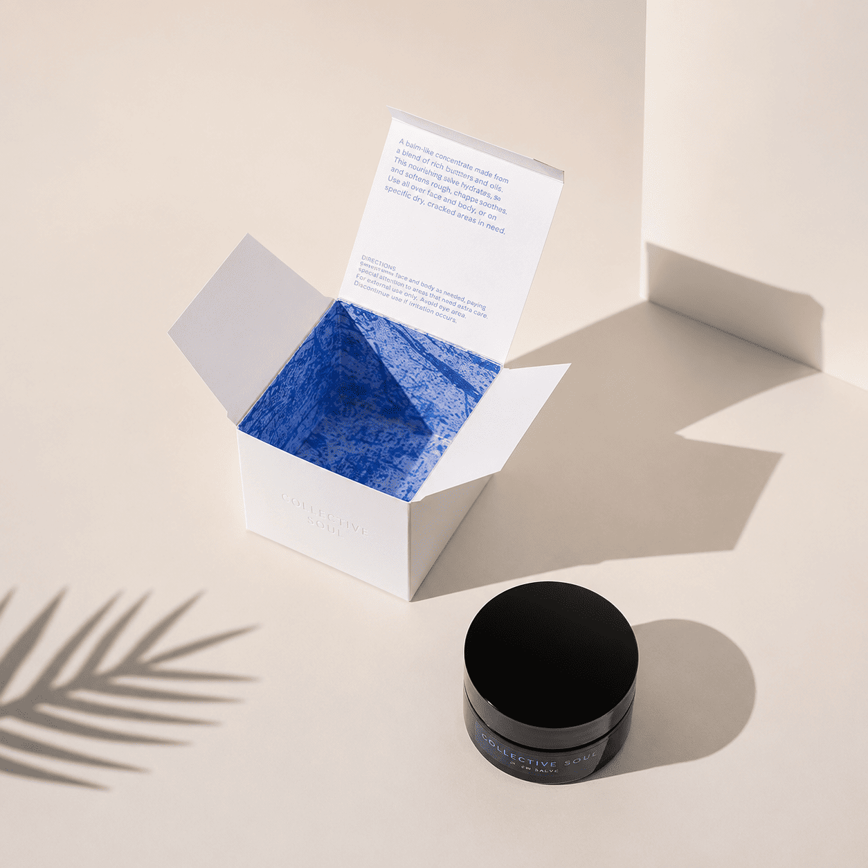 Bespoke cream boxes with a bold printed interior and a matching jar for a face and body balm brand